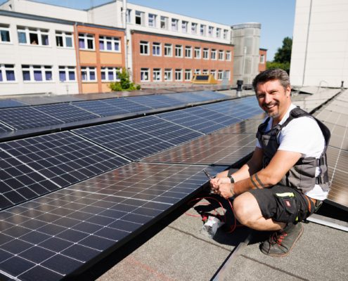 Montage einer Photovoltaikanlage auf einer gewerblichen Dachfläche.